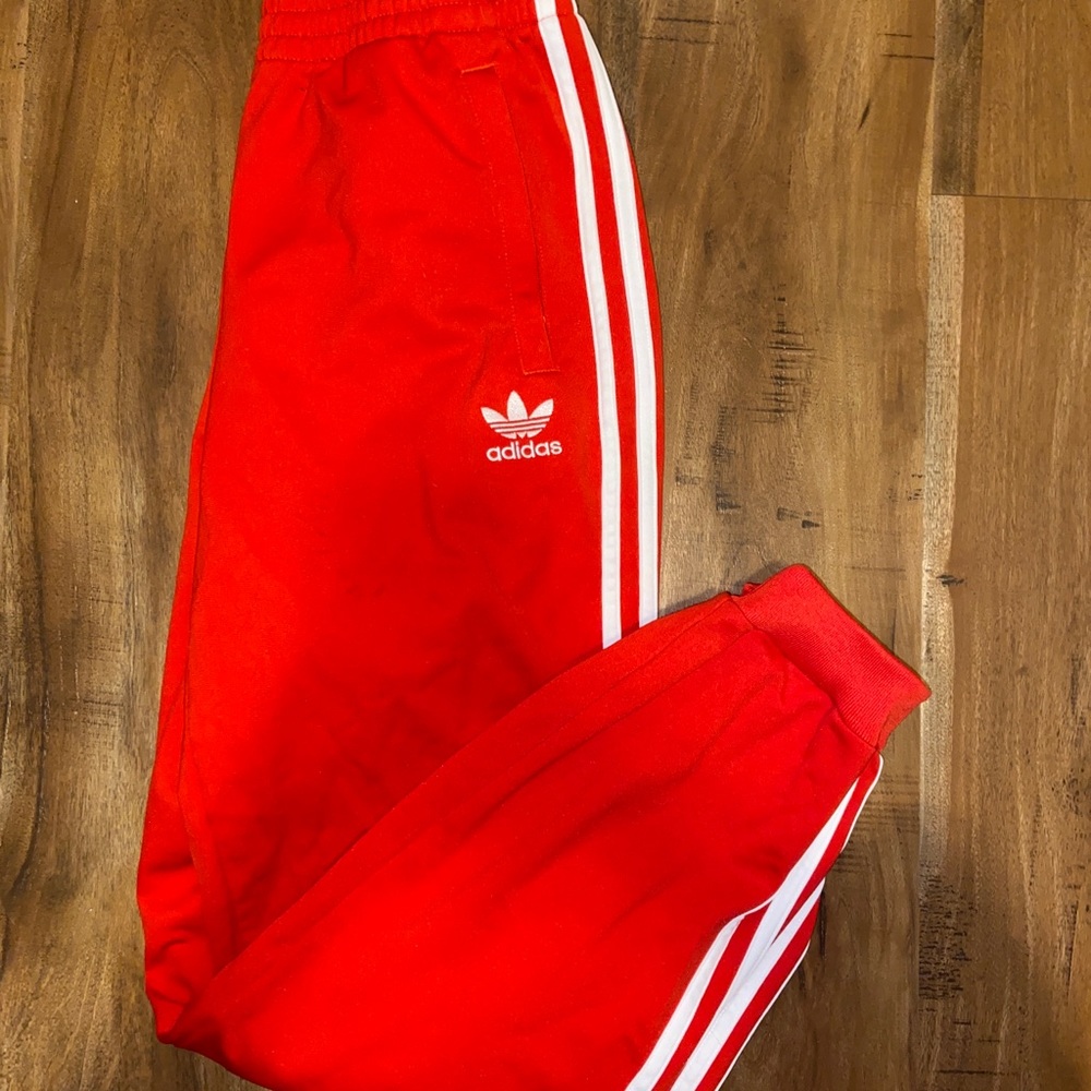 Red adidas track pants
